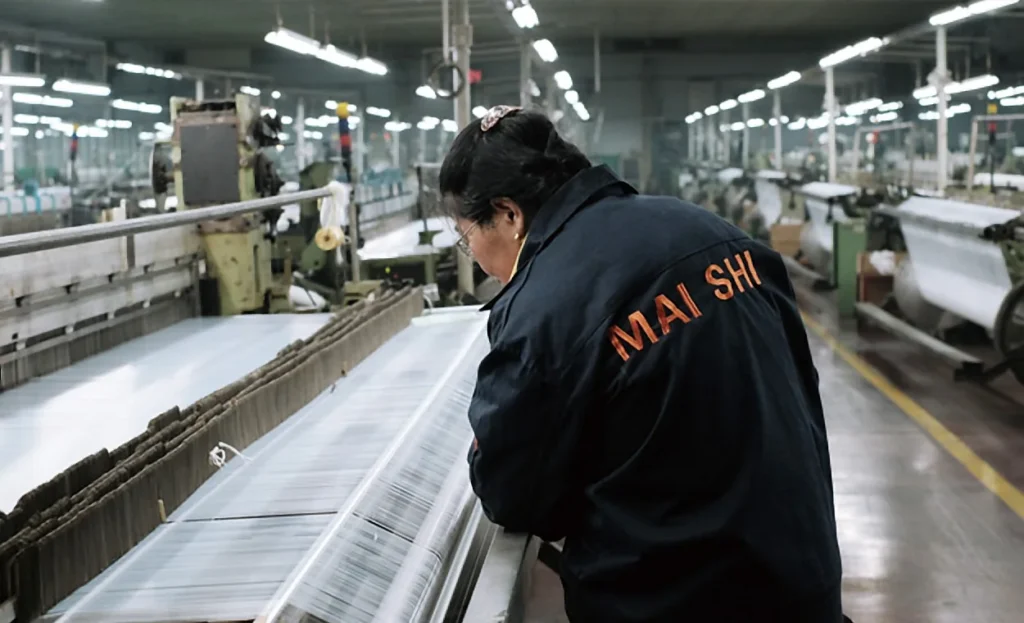 MAISHI worker at nylon mesh loom