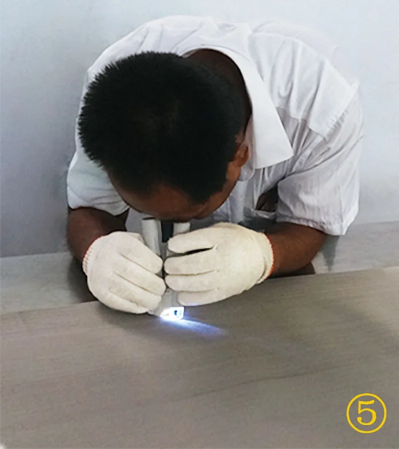 MAISHI worker inspecting mesh with magnifier
